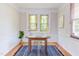 A cozy office with vintage-style stained glass windows, hardwood floors, and a modern desk and chair at 800 E Forest Hills Blvd, Durham, NC 27707