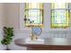 Close-up of a charming workspace with stained glass windows, a wooden desk, and vintage decor at 800 E Forest Hills Blvd, Durham, NC 27707
