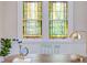 Close-up of a charming workspace with stained glass windows, a wooden desk, and vintage decor at 800 E Forest Hills Blvd, Durham, NC 27707