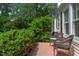 Inviting outdoor patio with wicker furniture, perfect for relaxing amidst lush landscaping at 800 E Forest Hills Blvd, Durham, NC 27707