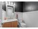 Bathroom with beadboard wainscoting, neutral walls and tile floors, and a shaker vanity at 825 Federal House Ave, Wake Forest, NC 27587