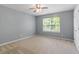 Bedroom with a ceiling fan and a window overlooking lush landscaping at 825 Federal House Ave, Wake Forest, NC 27587