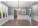 Dining room with chandelier, wainscoting, and large windows with shutters at 825 Federal House Ave, Wake Forest, NC 27587