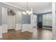 Open dining area with hard surface floors, neutral paint, white trim, and chandelier at 825 Federal House Ave, Wake Forest, NC 27587