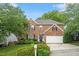 Charming brick home with green lawn, mature trees, and attached two car garage at 825 Federal House Ave, Wake Forest, NC 27587