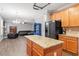 Open-concept kitchen with a large island and granite countertops, open to the living room area at 825 Federal House Ave, Wake Forest, NC 27587