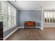Bright living room features hard surface floors, base trim, and large windows with shutters at 825 Federal House Ave, Wake Forest, NC 27587