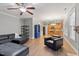 Living area with dark furniture, hardwood floors, a ceiling fan and an open concept to the kitchen at 825 Federal House Ave, Wake Forest, NC 27587