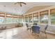 Bright sunroom featuring bamboo shades on all the windows, ceiling fan and a table with four chairs at 825 Federal House Ave, Wake Forest, NC 27587