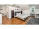 Comfortable bedroom featuring hardwood floors, a queen bed, and charming decor at 8420 Caldbeck Dr, Raleigh, NC 27615
