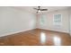 Bedroom with hardwood floors, a ceiling fan and natural light from two windows at 8420 Caldbeck Dr, Raleigh, NC 27615