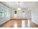 Spacious dining room featuring hardwood floors and classic white trim at 8420 Caldbeck Dr, Raleigh, NC 27615