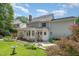 Lovely exterior elevation featuring a well-manicured yard, a birdbath and mature trees at 8420 Caldbeck Dr, Raleigh, NC 27615