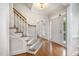 Inviting foyer featuring hardwood floors and a staircase with white railings at 8420 Caldbeck Dr, Raleigh, NC 27615