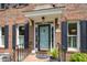 Elegant brick home entrance with a blue front door and black accents at 8420 Caldbeck Dr, Raleigh, NC 27615