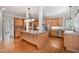 Open kitchen with stainless steel appliances, granite countertops, and light wood cabinetry at 8420 Caldbeck Dr, Raleigh, NC 27615