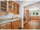 Detailed kitchen area showcasing granite countertops, light wood cabinets and stainless steel appliances at 8420 Caldbeck Dr, Raleigh, NC 27615