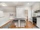 Charming kitchen area with granite counters, bar stool seating and stainless steel appliances at 8420 Caldbeck Dr, Raleigh, NC 27615