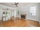 Open living area with a fireplace, ceiling fan, and hardwood flooring at 8420 Caldbeck Dr, Raleigh, NC 27615