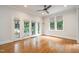 Bright sunroom with French doors leading to outdoor space and hardwood floors at 8420 Caldbeck Dr, Raleigh, NC 27615