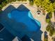 Aerial view of a backyard with a beautiful in-ground pool, fire pit, and Adirondack chairs at 8709 Kimalden Ct, Wake Forest, NC 27587