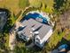Aerial view showcasing a home's spacious layout, pristine pool, and manicured landscaping in a desirable neighborhood at 8709 Kimalden Ct, Wake Forest, NC 27587