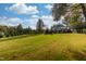 Spacious, well-maintained backyard with a line of trees, providing privacy and a picturesque setting for outdoor enjoyment at 8709 Kimalden Ct, Wake Forest, NC 27587