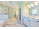 Bathroom with tiled floors, white vanity, framed mirror and glass shower at 8709 Kimalden Ct, Wake Forest, NC 27587