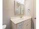 Bright bathroom features a modern vanity with a decorative mirror and brushed nickel fixtures at 8709 Kimalden Ct, Wake Forest, NC 27587