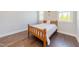 Bedroom with a wooden bed frame and lots of natural light at 8709 Kimalden Ct, Wake Forest, NC 27587