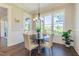 Cozy dining area featuring a round table, stylish chandelier, shiplap detail and lots of natural light at 8709 Kimalden Ct, Wake Forest, NC 27587