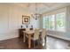 Elegant dining room featuring coffered ceilings, hardwood floors, natural light and modern chandelier at 8709 Kimalden Ct, Wake Forest, NC 27587