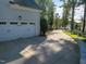 Exterior view features a home with a long driveway leading to a two-car garage at 8709 Kimalden Ct, Wake Forest, NC 27587
