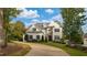 A beautiful two-story home featuring manicured lawn, professional landscaping and stone and shingle facade at 8709 Kimalden Ct, Wake Forest, NC 27587