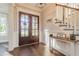 Inviting foyer with gleaming hardwood floors, staircase, and sunlit glass-paneled double front doors at 8709 Kimalden Ct, Wake Forest, NC 27587