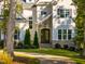 View of front door with stone archway and covered porch, framed by manicured landscaping at 8709 Kimalden Ct, Wake Forest, NC 27587