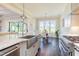 Modern kitchen featuring a large stainless steel sink, professional range and view to the breakfast area at 8709 Kimalden Ct, Wake Forest, NC 27587