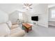 Lofted living room with TV, desk area, ceiling fan, and bright natural light at 8709 Kimalden Ct, Wake Forest, NC 27587