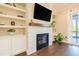 Living room with built-in shelving and cabinets surrounding a fireplace at 8709 Kimalden Ct, Wake Forest, NC 27587