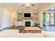 Comfortable living room with fireplace, built-ins, ceiling fan, and sliding door access to the porch at 8709 Kimalden Ct, Wake Forest, NC 27587