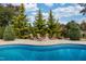 Beautiful pool and stone fire pit with Adirondack chairs for entertaining and relaxation at 8709 Kimalden Ct, Wake Forest, NC 27587