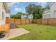Spacious backyard with a well-maintained lawn, a wooden fence, and a patio area at 902 B Oakland Ave, Durham, NC 27705