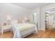 Inviting bedroom with light-colored walls, a cozy bed, and a view into the home's bathroom at 902 B Oakland Ave, Durham, NC 27705