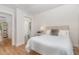 Serene bedroom with hardwood floors, neutral tones, and an attached bathroom at 902 B Oakland Ave, Durham, NC 27705