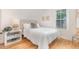 Bright bedroom with natural light, featuring a cozy bed and minimalist decor with light colored wall at 902 B Oakland Ave, Durham, NC 27705