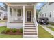Inviting covered front porch with white railings, and new landscaping at 902 B Oakland Ave, Durham, NC 27705