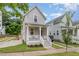 Inviting home with covered porch, white railing, green lawn, and quaint landscaping at 902 B Oakland Ave, Durham, NC 27705