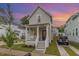 Charming home featuring a cozy front porch, manicured lawn, and a private driveway for easy parking at 902 B Oakland Ave, Durham, NC 27705