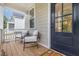 Inviting front porch with seating and stylish blue door, perfect for relaxing outdoors at 902 B Oakland Ave, Durham, NC 27705