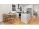 Stylish kitchen with stainless steel appliances, island, and a cozy dining setup for a comfortable meal at 902 B Oakland Ave, Durham, NC 27705